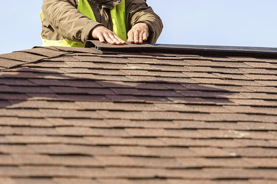 roofer inspecting a home in Rhode Island