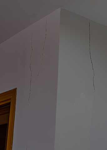 Cracked interior drywall caused by damaged roof