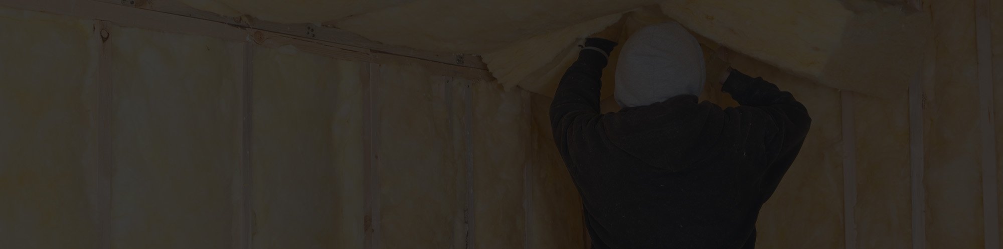Roofing contractor installing attic insulation in New Bedford home