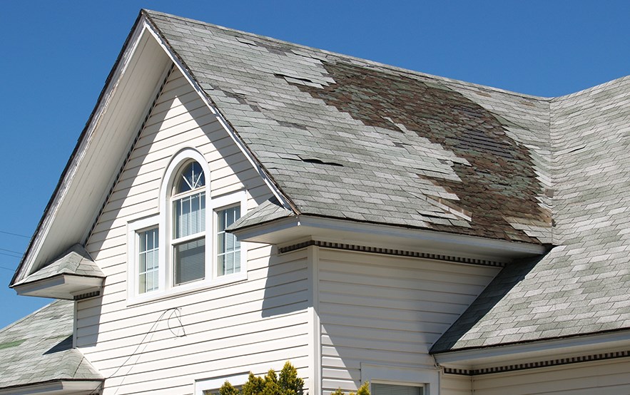 Roof with missing shingles from storm in New Bedford