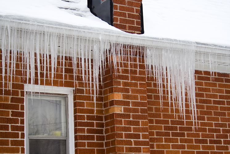 Large icicles hanging from roof and gutters