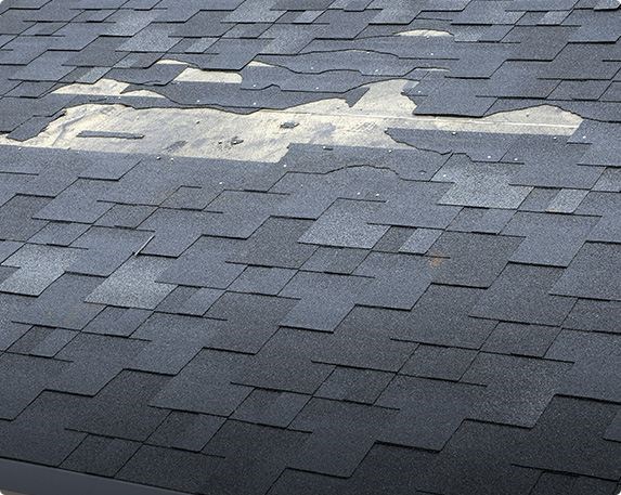 Damaged roofing shingles on home in Massachusetts
