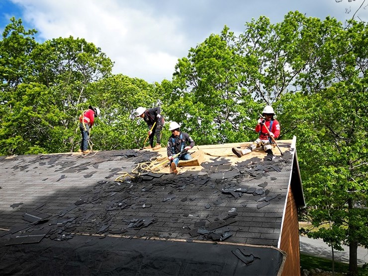 Roofing contractors removing old roof