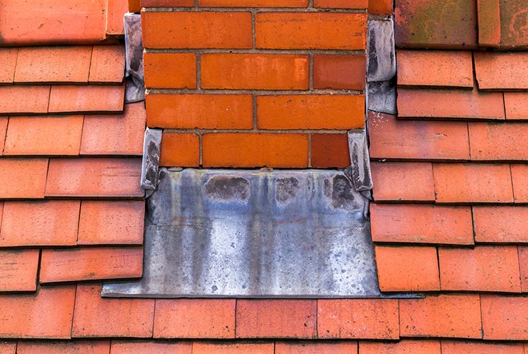 Rusted chimney flashing on roof in New Bedford, MA